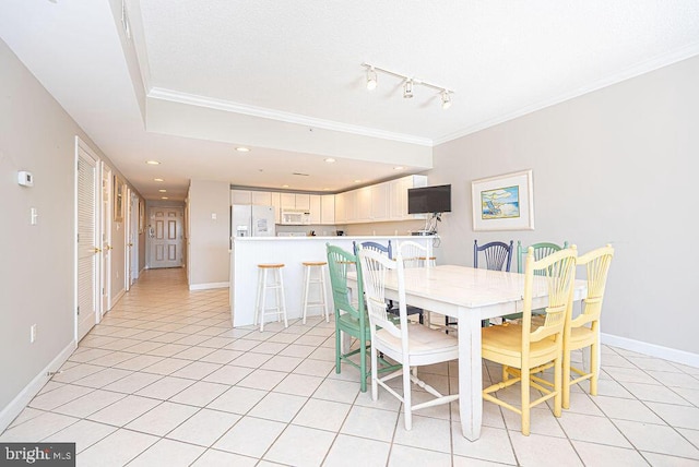 dining room featuring track lighting, recessed lighting, light tile patterned flooring, crown molding, and baseboards