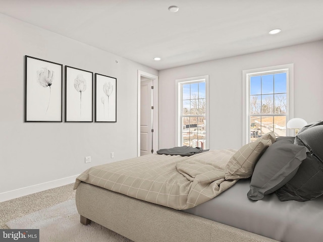 carpeted bedroom featuring recessed lighting and baseboards