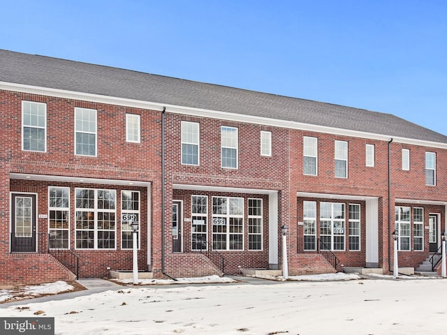 rear view of property with brick siding