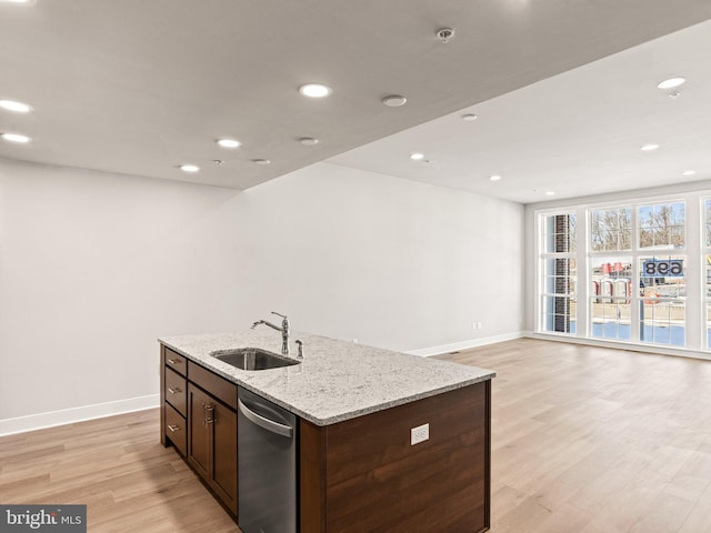 kitchen featuring a sink, an island with sink, light wood-type flooring, recessed lighting, and stainless steel dishwasher