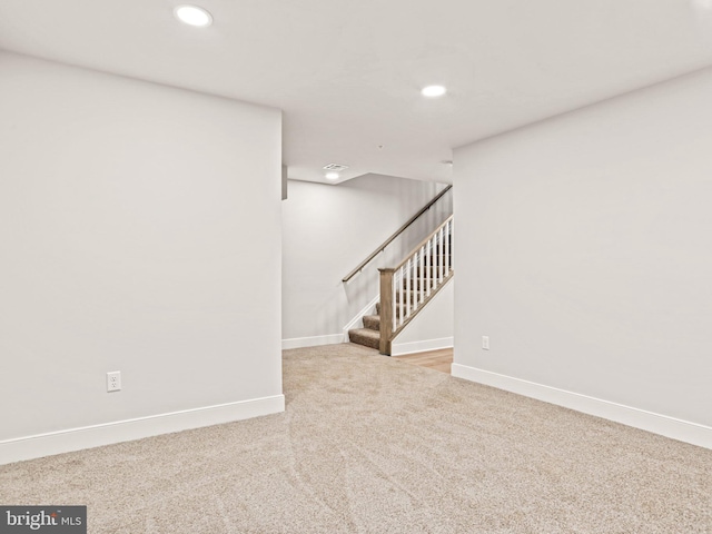 basement with stairway, recessed lighting, baseboards, and carpet