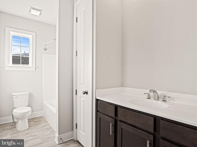 bathroom with wood finish floors, visible vents, toilet, washtub / shower combination, and baseboards