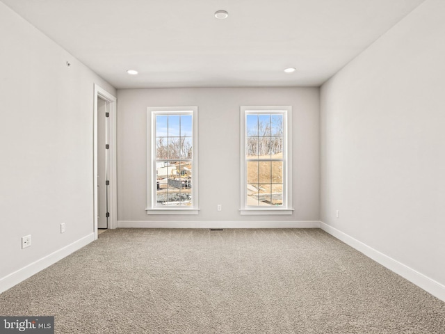 empty room featuring recessed lighting, baseboards, and carpet floors