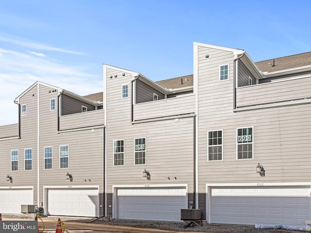 rear view of property with a balcony and central AC