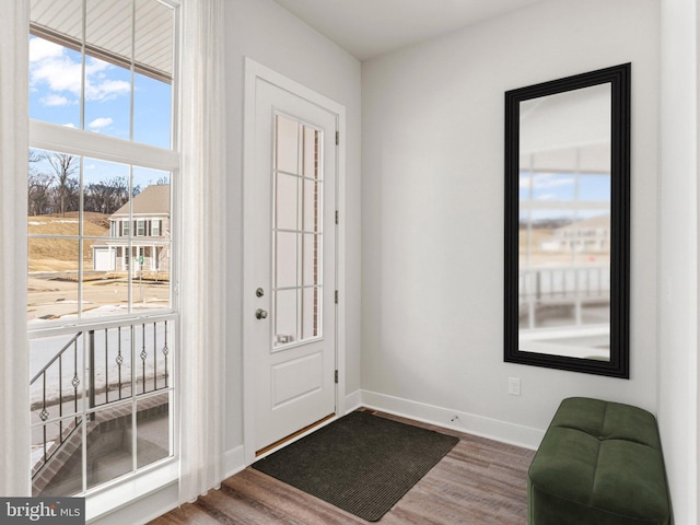 foyer with wood finished floors and baseboards