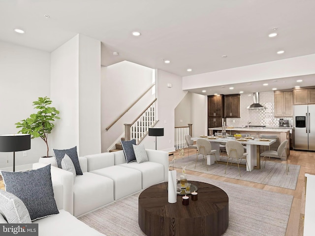 living room featuring stairway, recessed lighting, and light wood-style floors