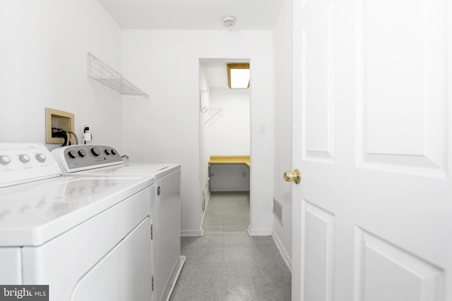 clothes washing area with washer and dryer, laundry area, baseboards, and visible vents