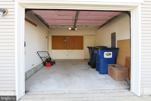 garage with electric panel and a garage door opener