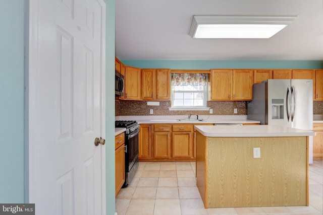 kitchen with a sink, light countertops, tasteful backsplash, and stainless steel appliances