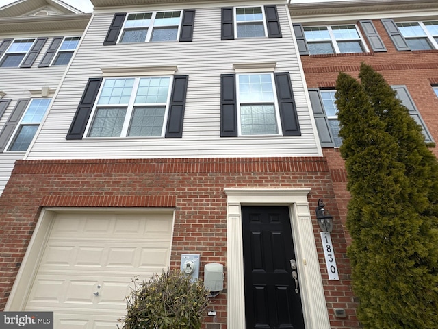 townhome / multi-family property with brick siding