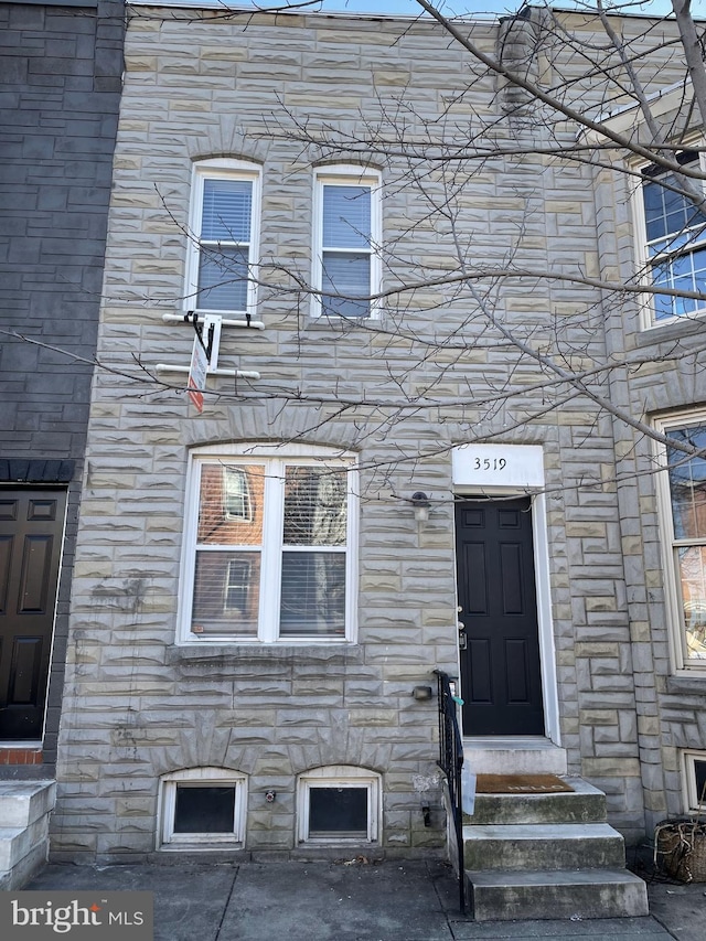 entrance to property featuring stone siding