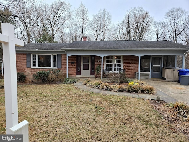 single story home with a front lawn, covered porch, brick siding, and a chimney