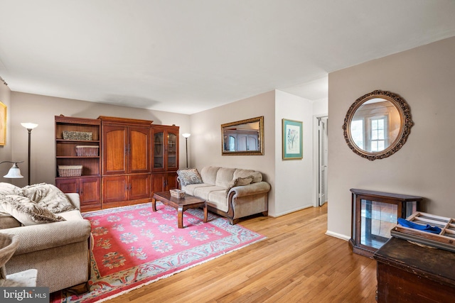 living room with baseboards and light wood finished floors