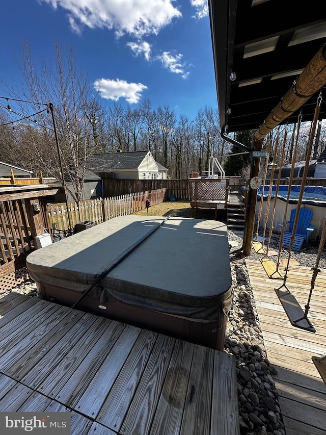 wooden deck with fence private yard and a covered hot tub