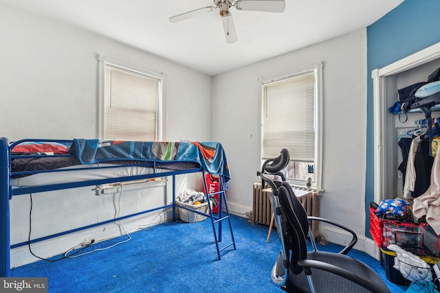 bedroom with baseboards, ceiling fan, and radiator