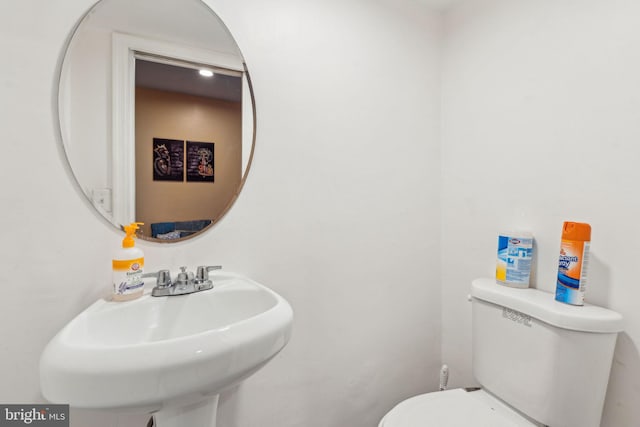 half bathroom featuring a sink and toilet