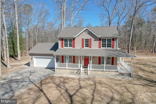 view of front facade with a porch, an attached garage, driveway, and a shingled roof