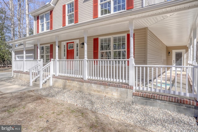 view of exterior entry featuring a porch