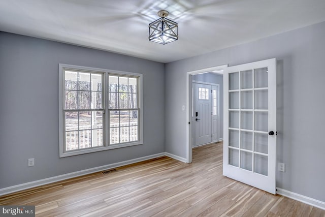 interior space featuring visible vents, baseboards, and wood finished floors