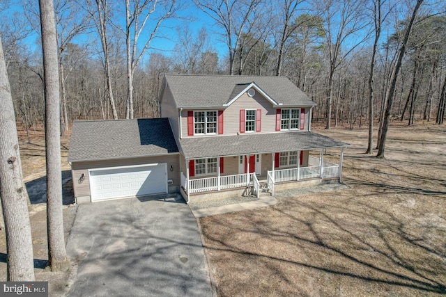 view of front facade featuring a garage, roof with shingles, a porch, and driveway