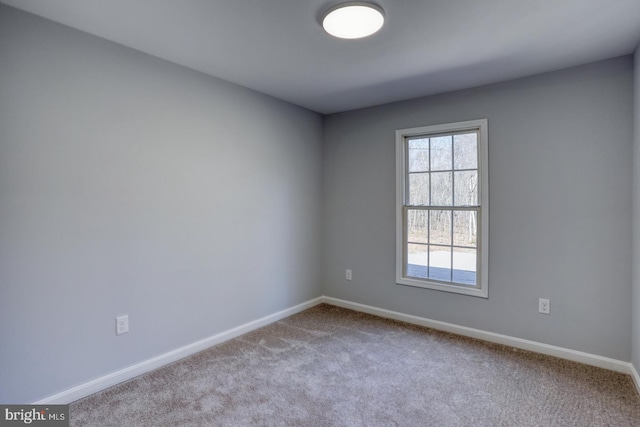 carpeted empty room with baseboards