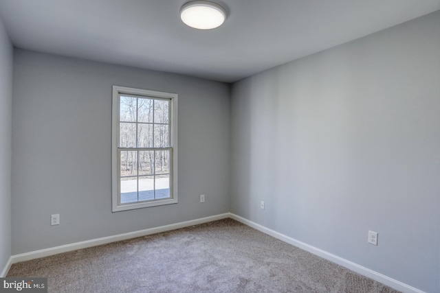 empty room with baseboards and carpet floors