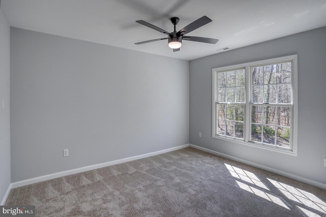 spare room featuring ceiling fan, baseboards, and carpet floors