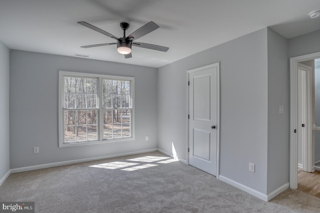 unfurnished bedroom featuring visible vents, baseboards, carpet, and ceiling fan