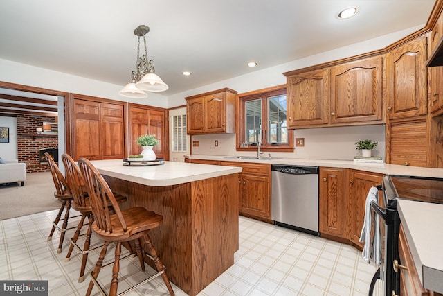 kitchen with black electric range oven, a sink, stainless steel dishwasher, a center island, and light countertops