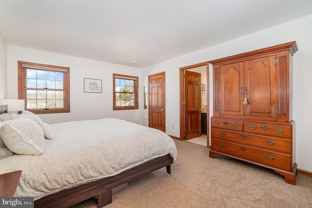 bedroom featuring baseboards and light carpet