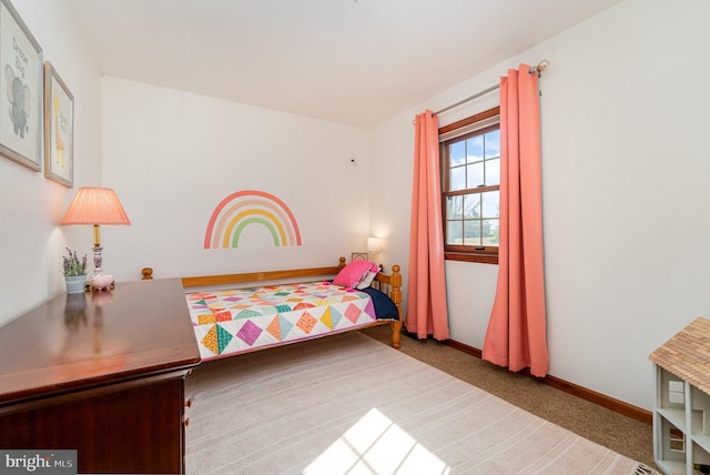 bedroom featuring baseboards and carpet floors