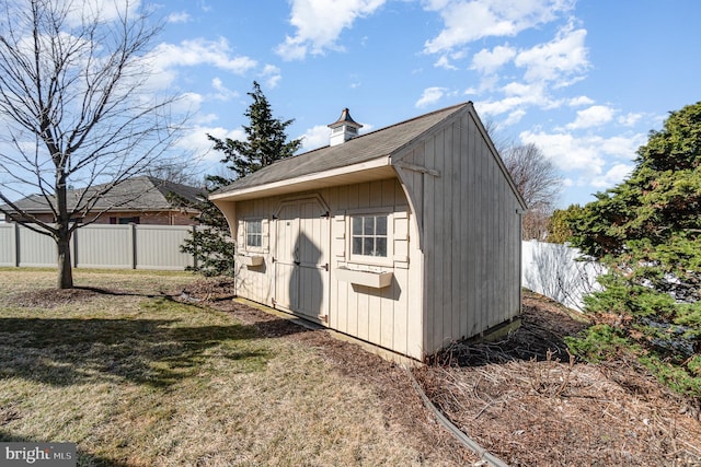 view of shed featuring fence