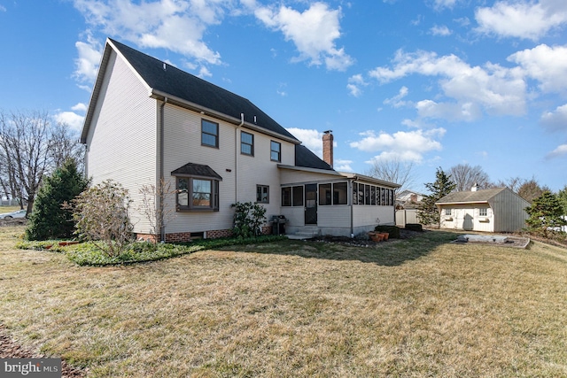 back of house with a chimney, a yard, and a sunroom