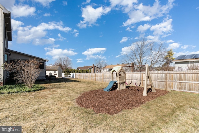 view of yard featuring a playground and fence