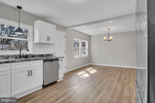 kitchen featuring dishwasher, dark stone countertops, light wood-style floors, a notable chandelier, and white cabinetry