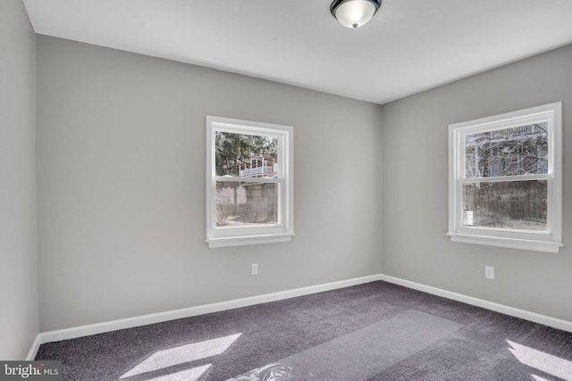 carpeted spare room with baseboards