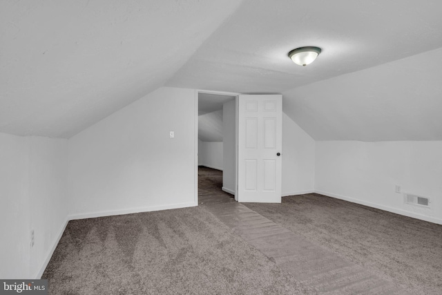 bonus room featuring visible vents, carpet flooring, baseboards, and lofted ceiling