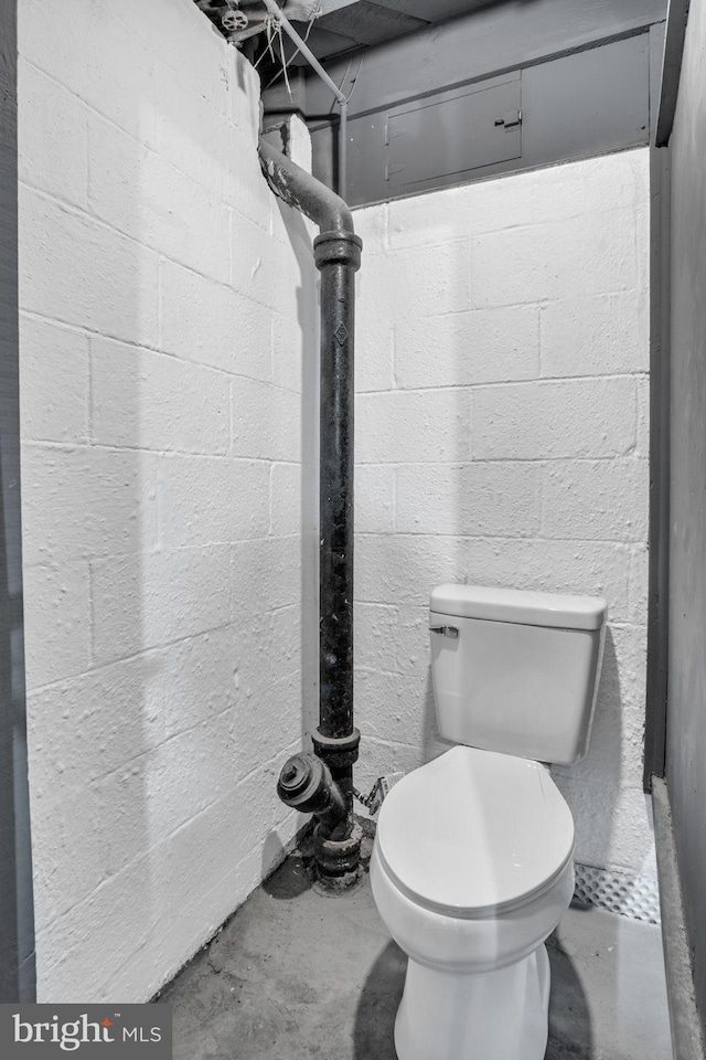 bathroom featuring toilet and unfinished concrete flooring