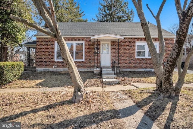 bungalow-style house with brick siding, crawl space, and roof with shingles