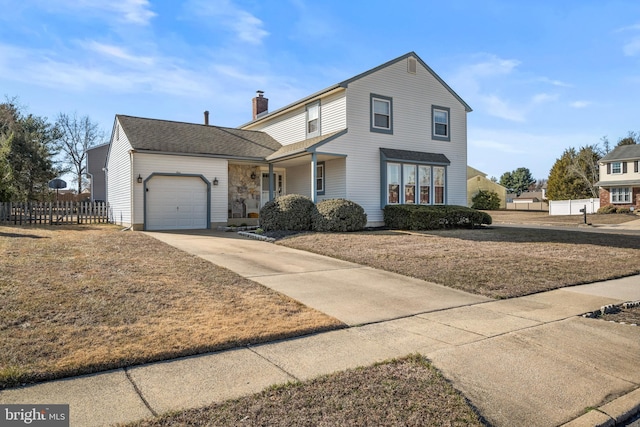 traditional home featuring a shingled roof, fence, concrete driveway, a chimney, and a garage