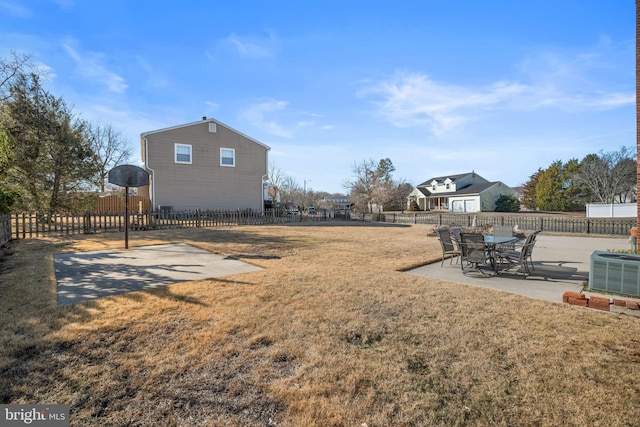 view of yard featuring central air condition unit, a fenced backyard, and a patio area