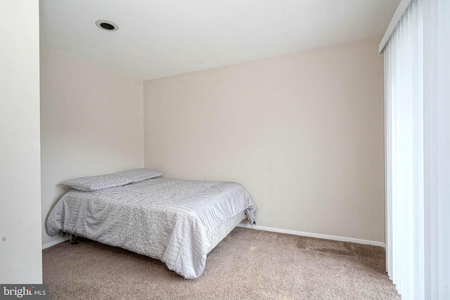 carpeted bedroom with baseboards