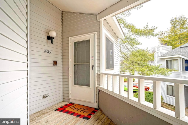 view of exterior entry with a balcony