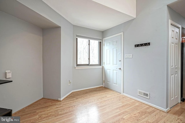 interior space featuring wood finished floors, visible vents, and baseboards