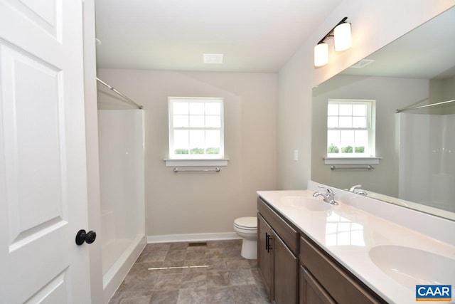 full bathroom featuring a sink, a shower, and a healthy amount of sunlight
