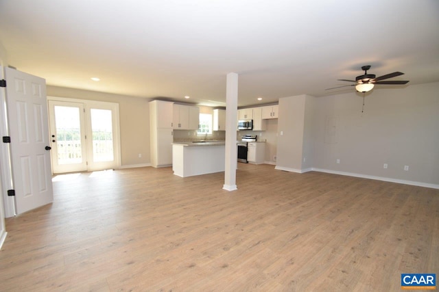 unfurnished living room with recessed lighting, baseboards, light wood-style floors, and a ceiling fan