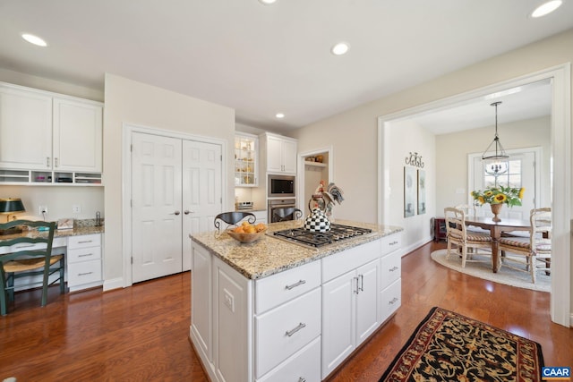 kitchen with white cabinetry, dark wood-type flooring, appliances with stainless steel finishes, and built in study area