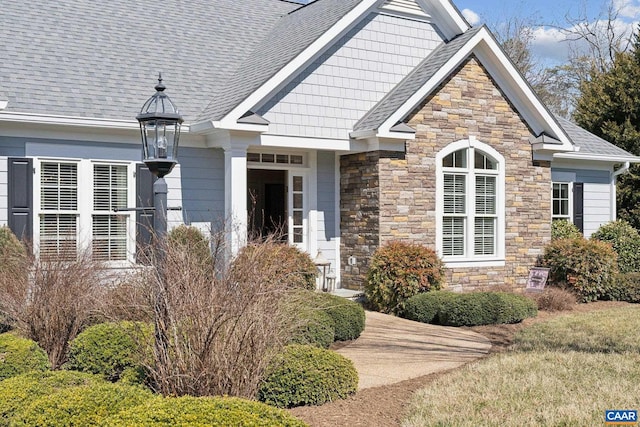 entrance to property with a shingled roof