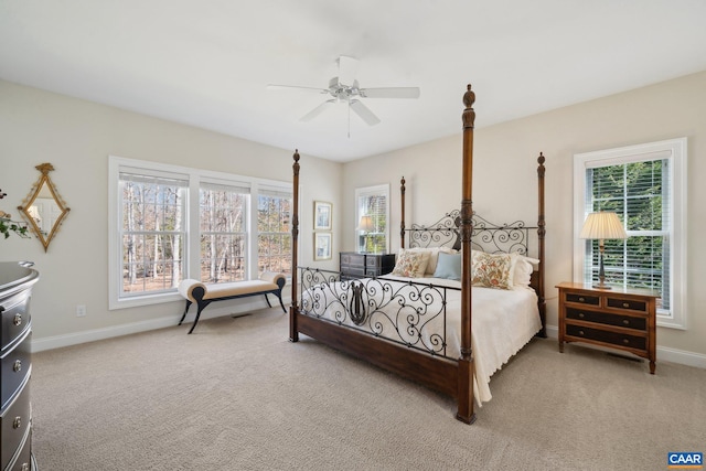 bedroom with baseboards, light carpet, and a ceiling fan