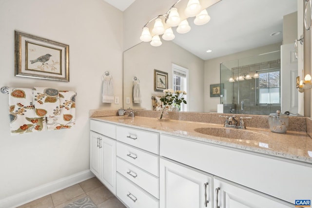 bathroom with tile patterned flooring, a stall shower, a wealth of natural light, and a sink